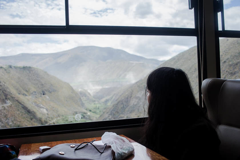 A girl on Tren de la Libertad in Ecuador, enjoying the view.