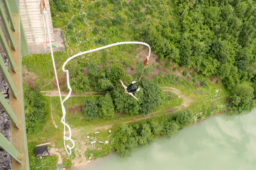 Girl bungee jumping from Jauntal bridge in Austria